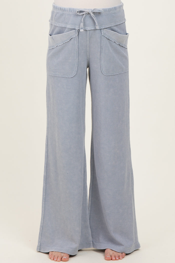 maternity wear light blue wide-leg pants with a drawstring waist and front pockets