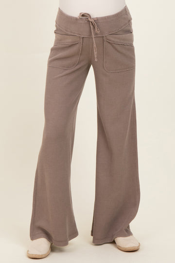 woman wearing light brown wide leg maternity pants with drawstring and front pockets