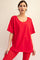 woman wearing a bright red oversized v-neck t-shirt with loose sleeves and paired with red leggings