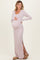 woman wearing a light purple ribbed maternity maxi dress with side slits and cradling her baby bump