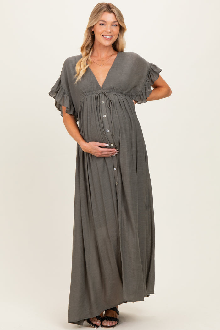 woman wearing a grey maternity maxi dress with short ruffle sleeves and a button-down front, holding her baby bump