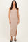 woman wearing a beige ribbed midi dress with a lace trim and side slit, standing against a neutral background