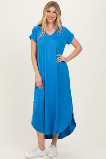 woman wearing a bright blue short sleeve maxi dress with a v-neck and side slits