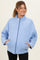 woman wearing a light blue quilted maternity jacket with side pockets and a high collar