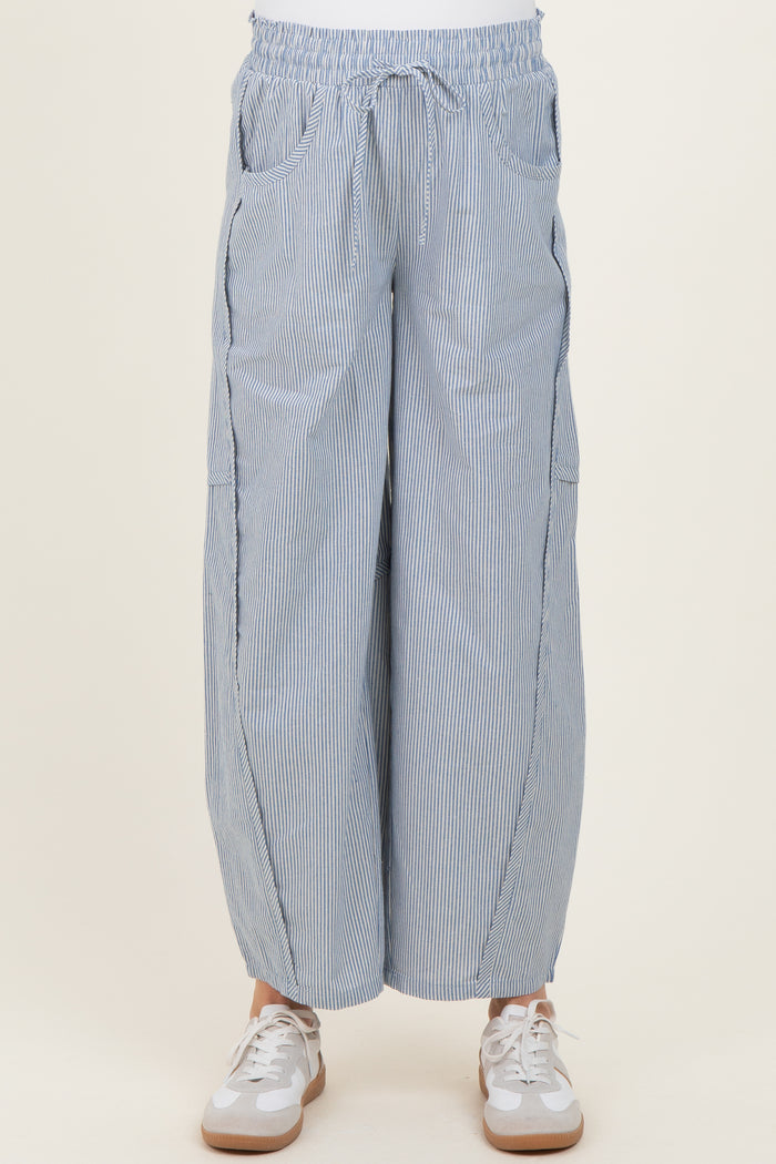 maternity wear striped wide-leg pants with an elastic waistband and side pockets, worn with white sneakers