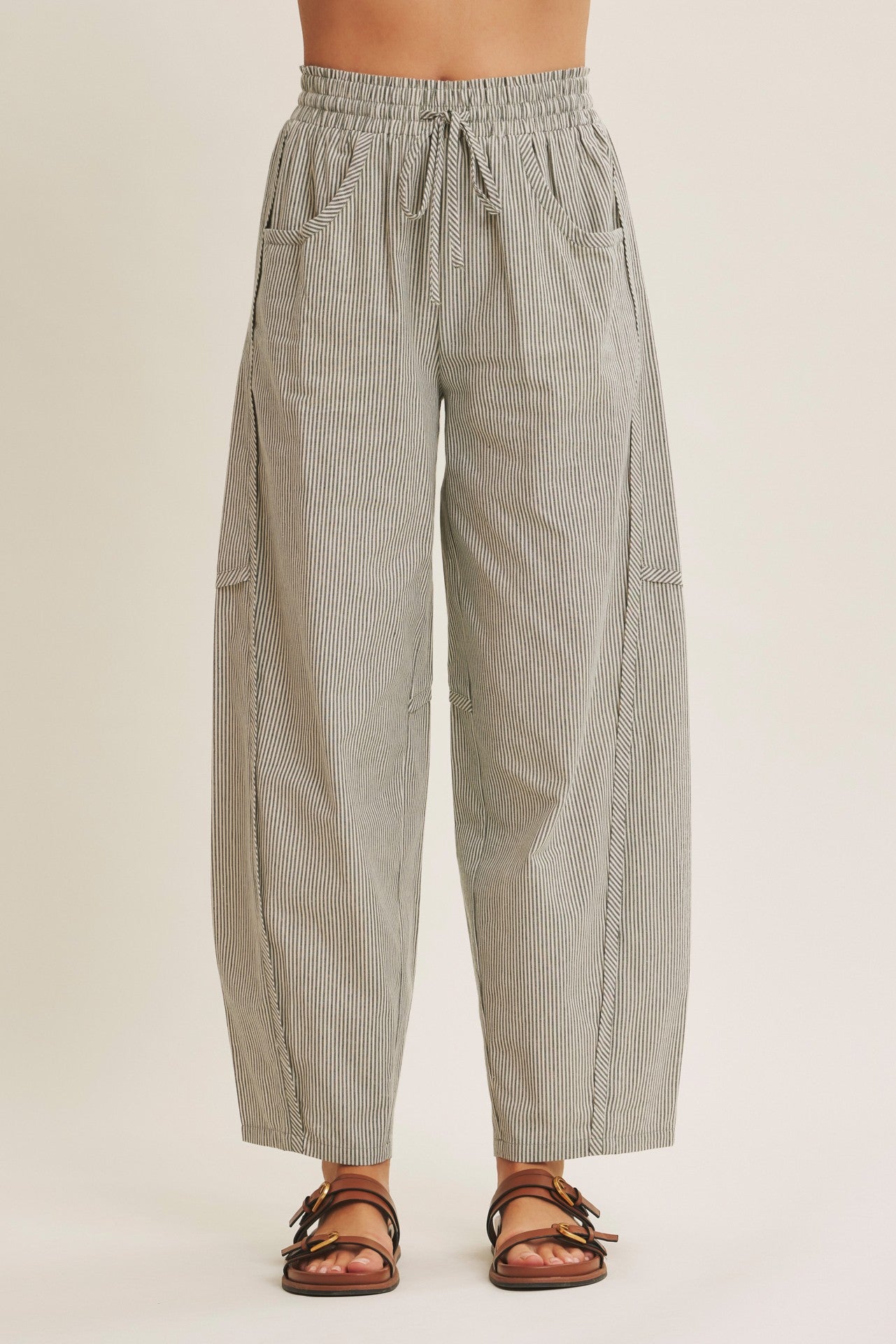 woman wearing black and white striped wide-leg pants with an elastic waistband and side pockets