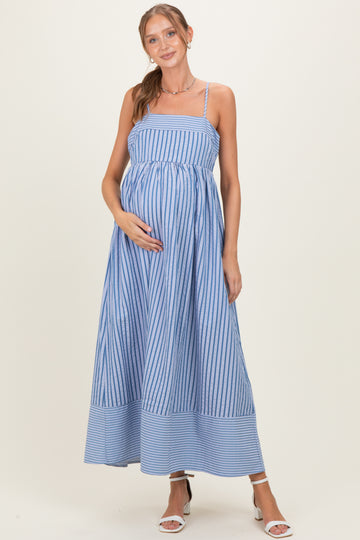 woman wearing a blue and white striped maternity maxi dress and holding her baby bump