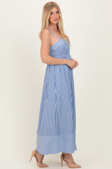 woman wearing a blue and white striped maxi dress with spaghetti straps and a flowy silhouette