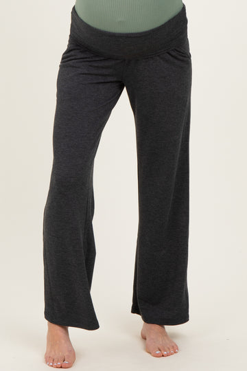 woman wearing black maternity lounge pants with a wide waistband and relaxed fit