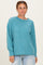 woman wearing a teal ribbed long sleeve pullover sweater with a loose fit and drop shoulders