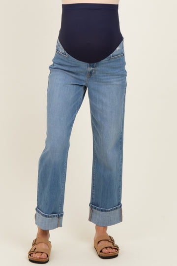 woman wearing blue maternity jeans with a navy belly panel and rolled cuffs