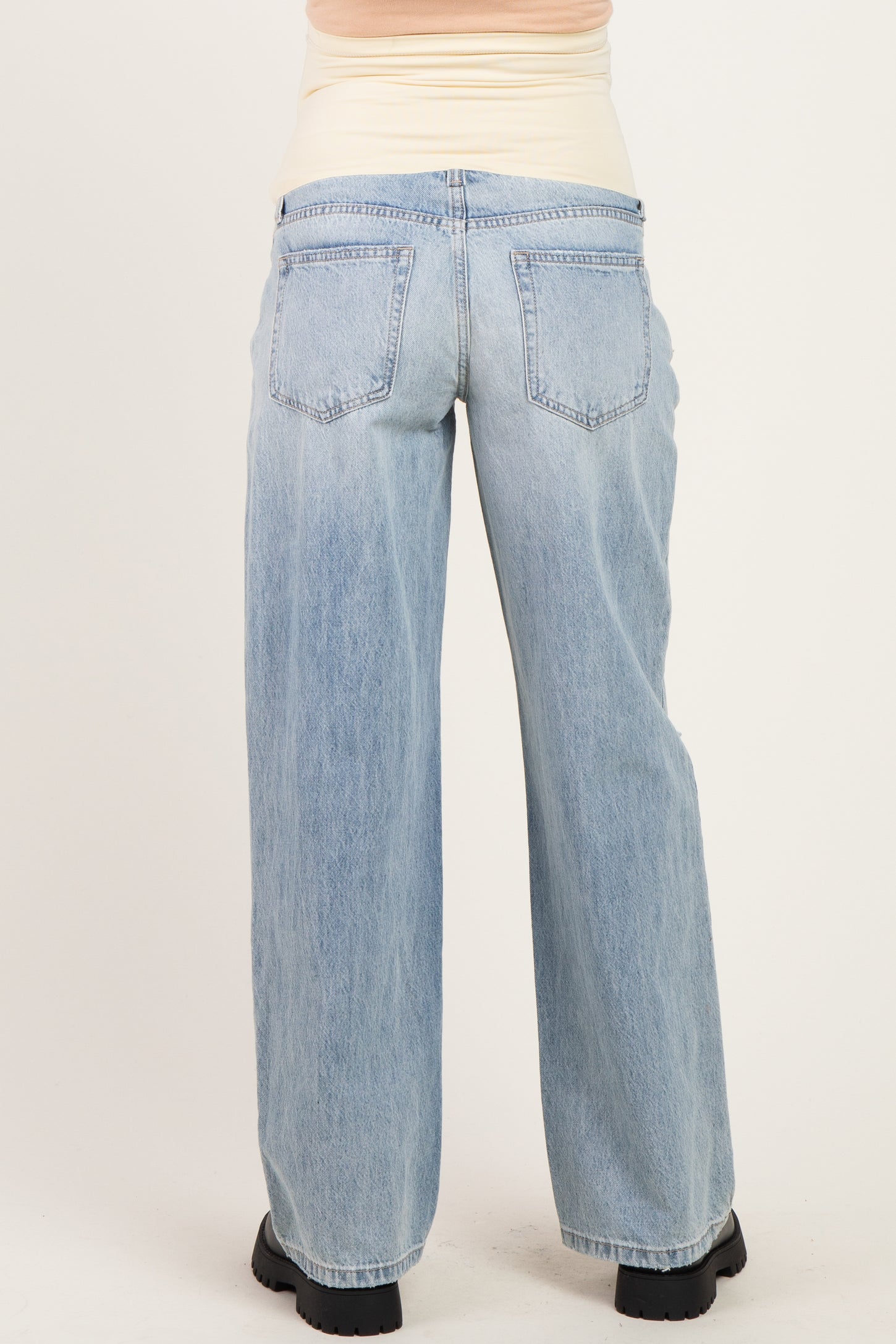 woman wearing light blue maternity wide-leg jeans, shown from the back, with a comfortable waistband