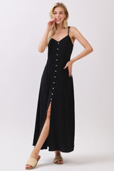 woman wearing a black button-down maxi dress with a thigh-high slit and spaghetti straps