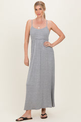 woman wearing a gray and white striped maxi dress with a fitted bodice and relaxed skirt