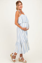 woman wearing a white and blue striped maternity dress with ruffles and holding her baby bump