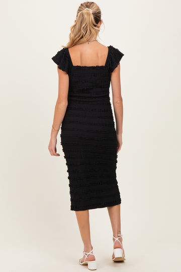 woman wearing a black fitted maternity dress with flutter sleeves, shown from the back