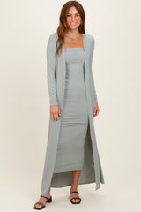 woman wearing a light green ribbed two-piece dress set with a long cardigan and fitted dress