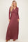 woman wearing a long sleeve burgundy maxi dress with a wrap style and fitted waist
