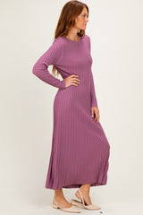 woman wearing a long sleeve ribbed maxi dress in mauve with a relaxed fit and side slits