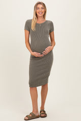 woman wearing a ribbed olive green maternity dress and holding her baby bump