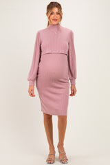woman wearing a light purple ribbed long sleeve maternity dress with a fitted silhouette and a visible baby bump
