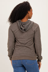woman wearing a grey hoodie with a relaxed fit and a front pocket, styled with blue jeans from the back