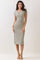 woman wearing a striped midi dress with short sleeves and a keyhole neckline, standing in neutral background