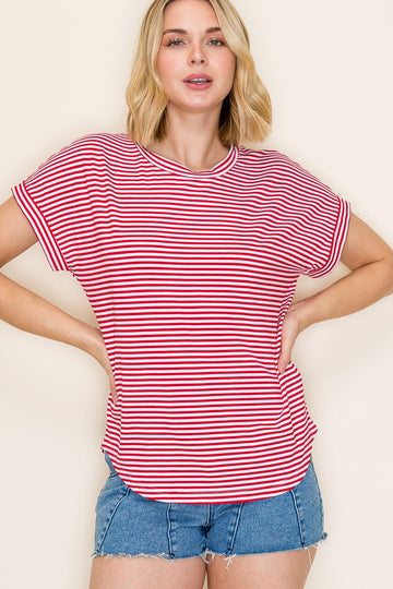 woman wearing a red and white striped short sleeve top and blue denim shorts