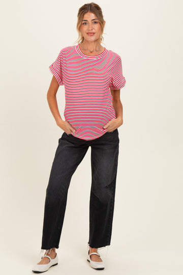 woman wearing a red and white striped maternity t-shirt with rolled sleeves and black maternity jeans, showing baby bump