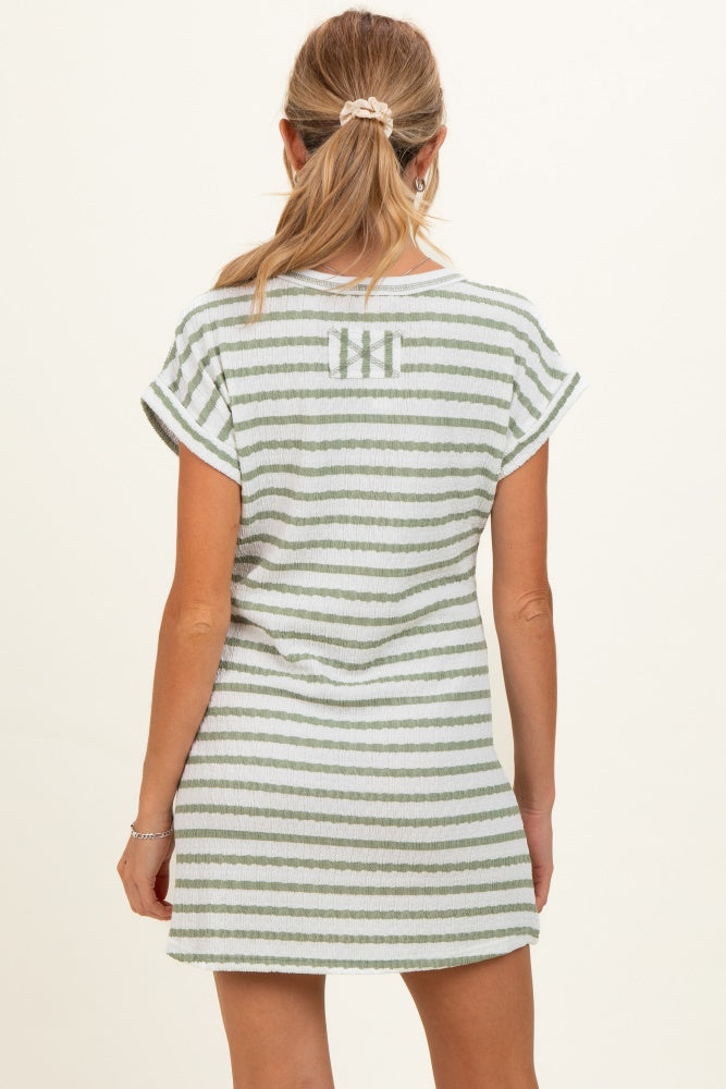woman wearing a green and white striped maternity dress with short sleeves and a relaxed fit