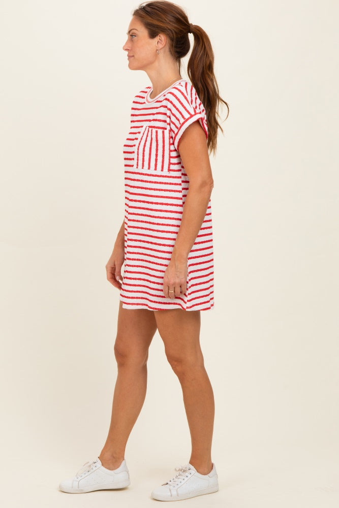 woman wearing a red and white striped short sleeve dress with a chest pocket and white sneakers