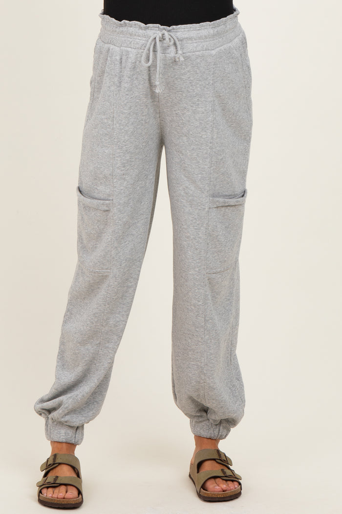 woman wearing light gray maternity sweatpants with drawstring waist and side pockets