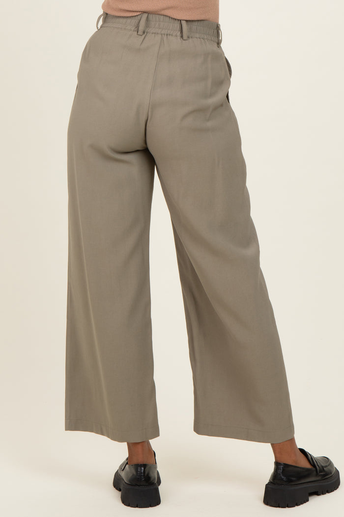 woman wearing light gray wide-leg maternity trousers with an elastic waistband and pockets, viewed from the back