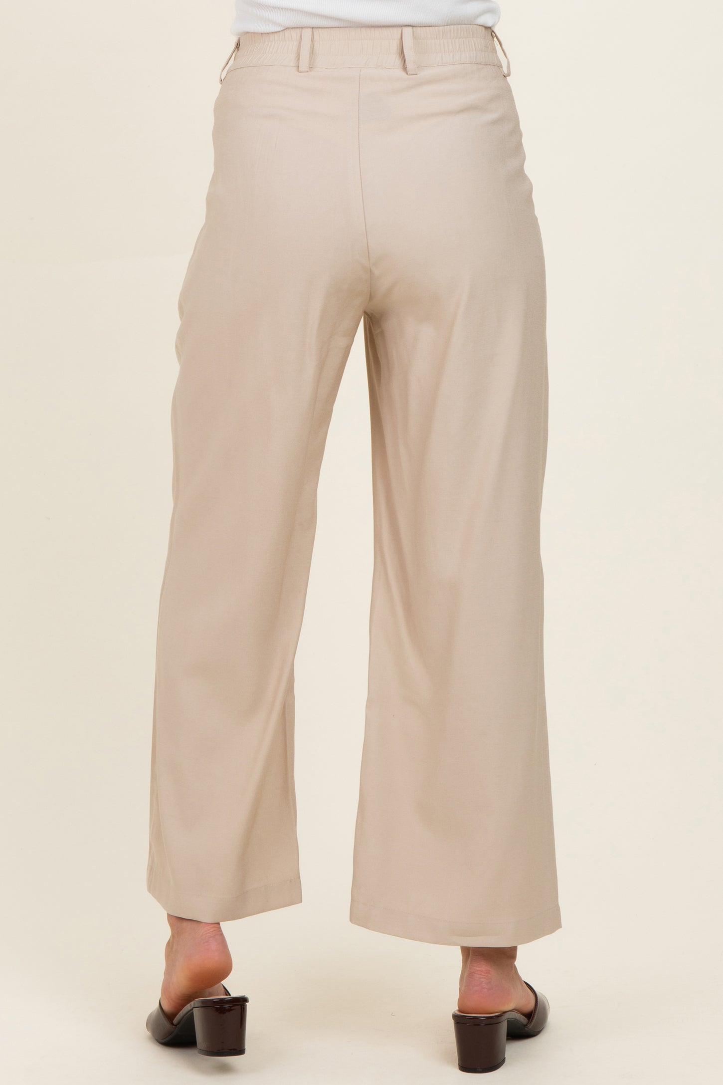 woman wearing light beige wide-leg maternity pants, viewed from the back
