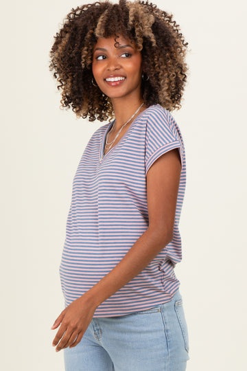 woman wearing a striped maternity top with short sleeves and a visible baby bump