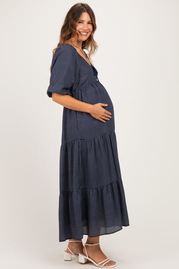 woman wearing a navy checkered maternity dress with tiered skirt and baby bump visible