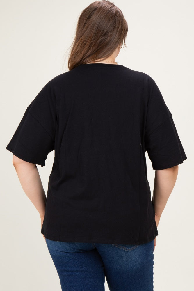 woman wearing a black maternity plus size top with a relaxed fit and short sleeves, shown from the back