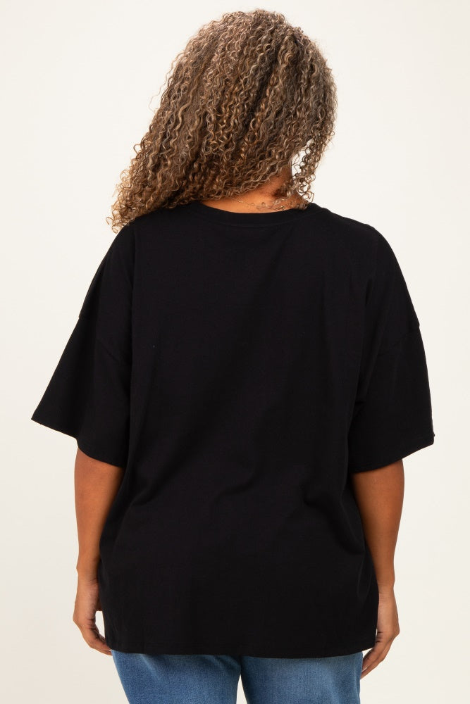 woman wearing a black oversized t-shirt with a relaxed fit and rolled sleeves, seen from the back