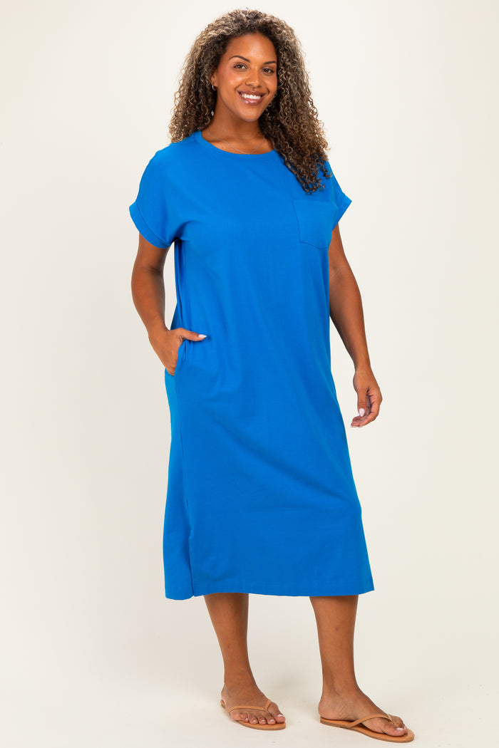 woman wearing a bright blue short sleeve plus-size dress with a pocket and relaxed fit