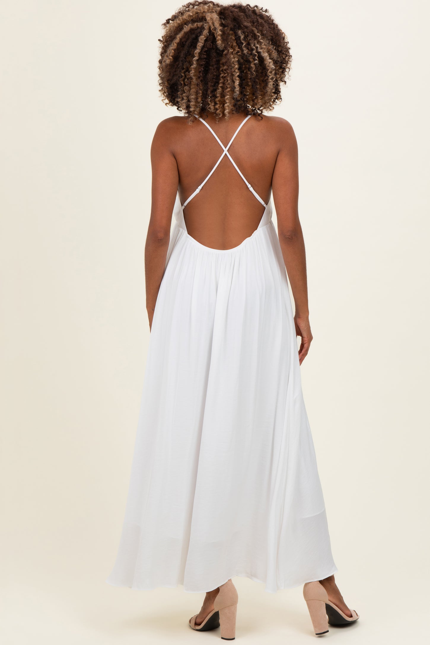 maternity wear white maxi dress with a cross-back design and flowing skirt, model shown from the back
