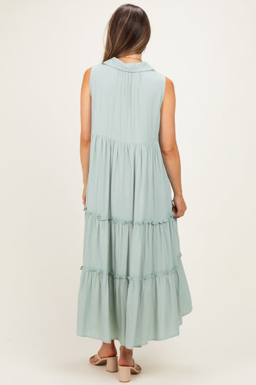 woman wearing a sleeveless light green maternity maxi dress with tiered ruffles, showing the back view
