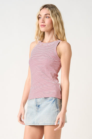 woman wearing a red and white striped tank top with a round neckline and a light blue denim mini skirt