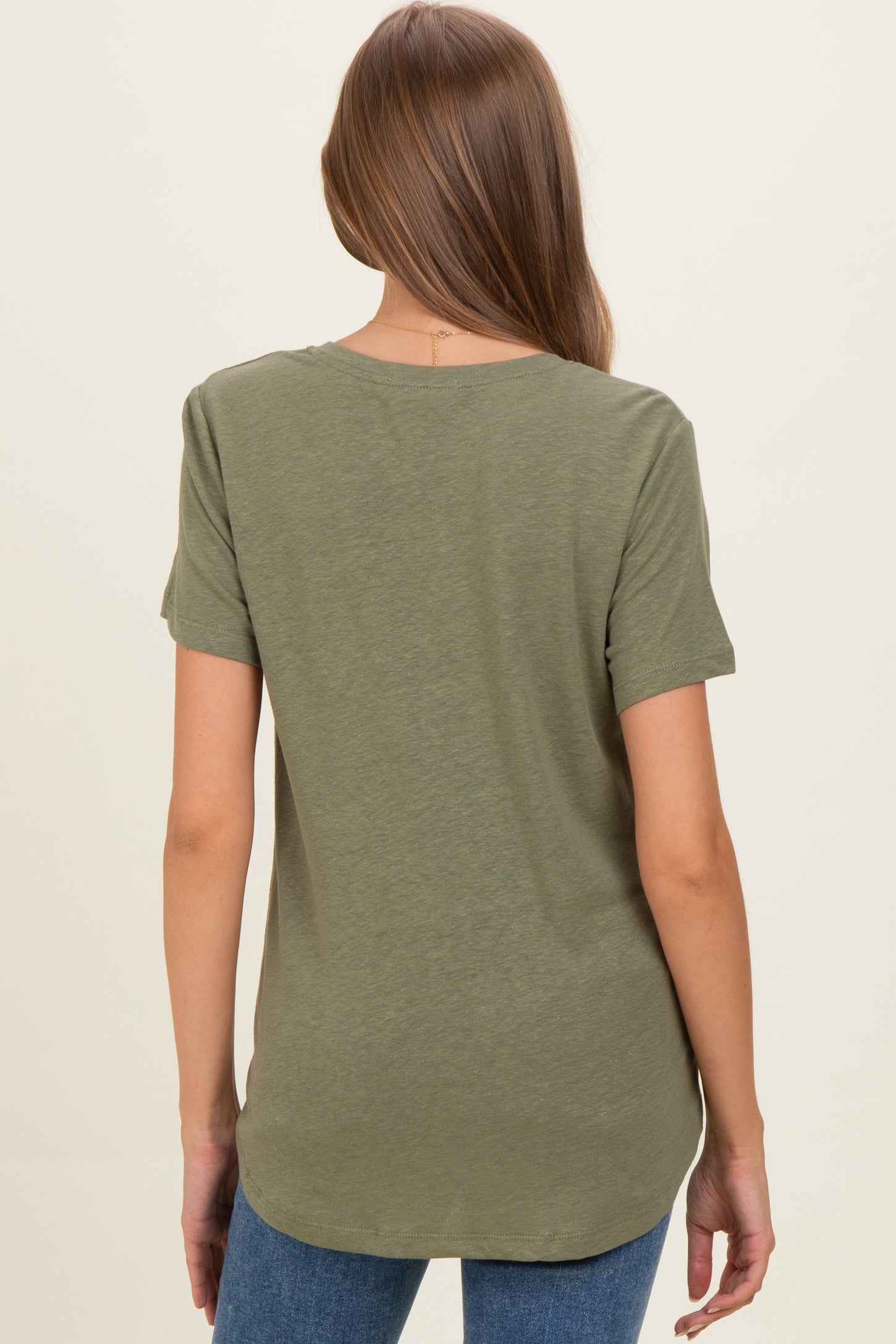 woman wearing a dark green maternity t-shirt with a relaxed fit and short sleeves, back view