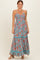 woman wearing a floral print maxi dress in blue with red and orange flowers and adjustable spaghetti straps