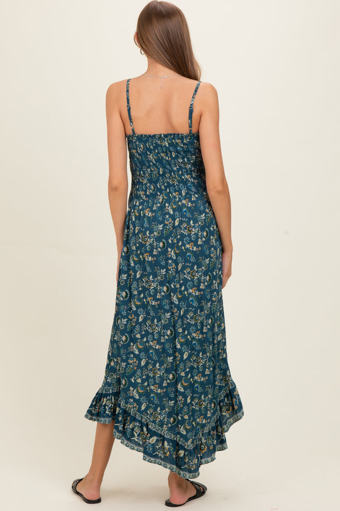 woman wearing a floral pattern maternity maxi dress with a ruffled hem and adjustable straps, seen from the back