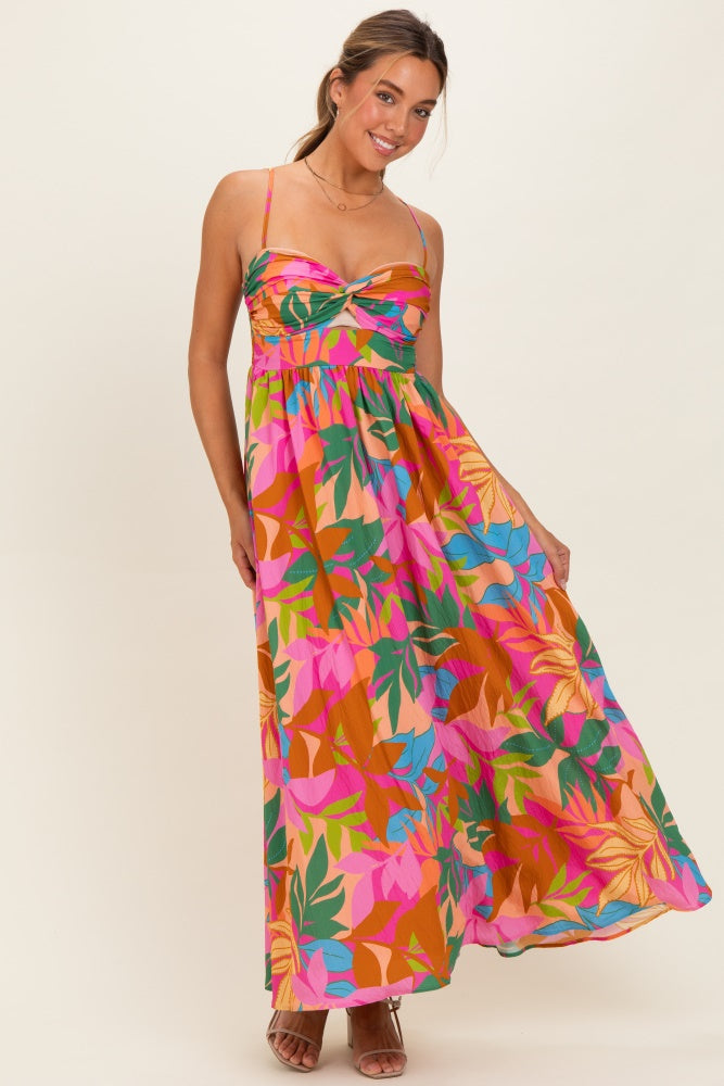 woman wearing a colorful floral maxi dress with a sweetheart neckline and spaghetti straps