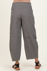 woman wearing black and white striped maternity wide-leg pants, viewed from the back