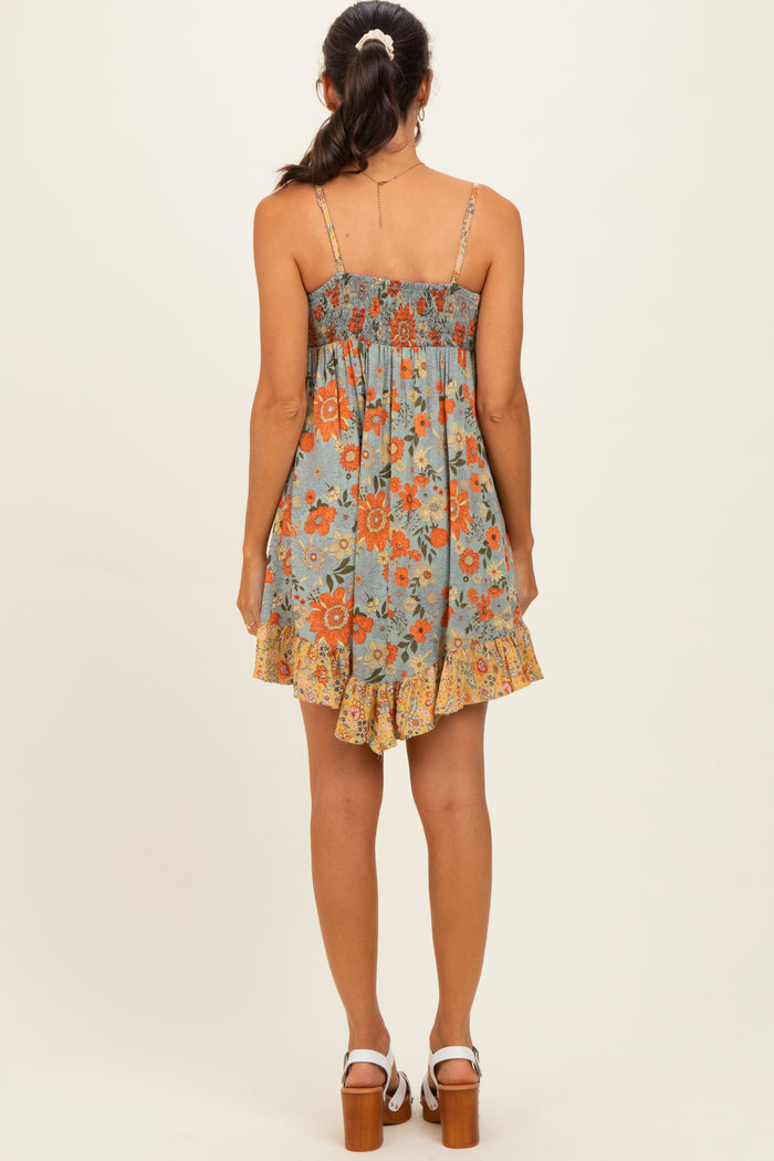 woman wearing a blue floral sundress with a smocked bodice and ruffled hem, seen from the back