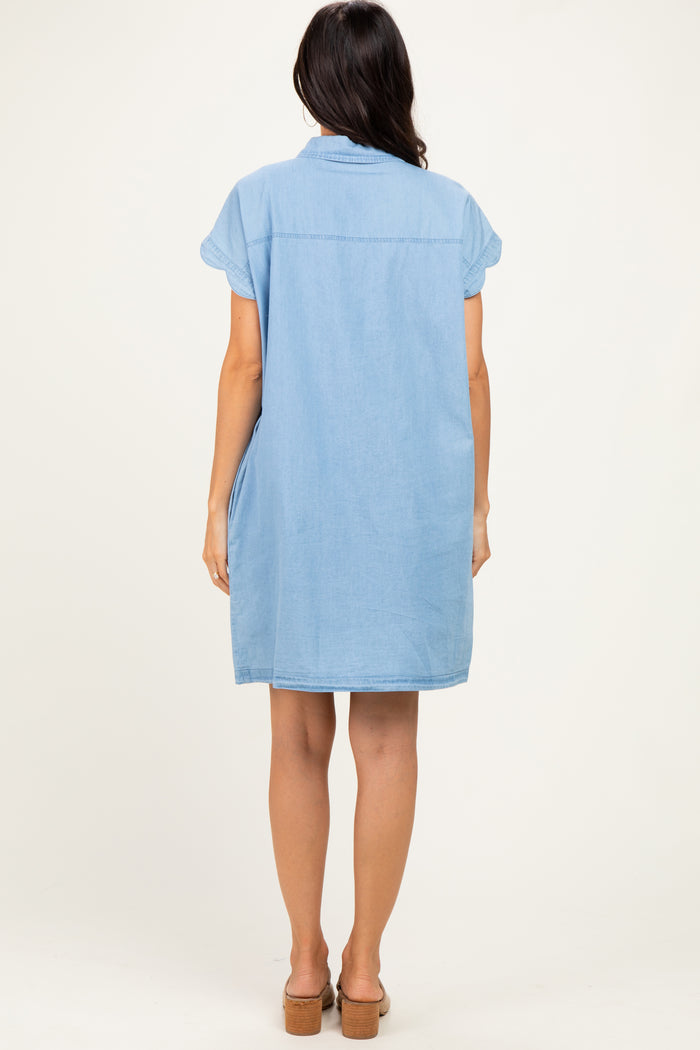 woman wearing a light blue denim shirt dress with short sleeves and a relaxed fit, shown from the back