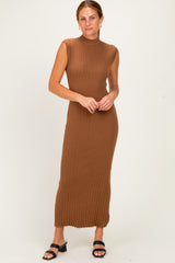 woman wearing a brown ribbed knit sleeveless maxi dress with a high neckline and a fitted silhouette